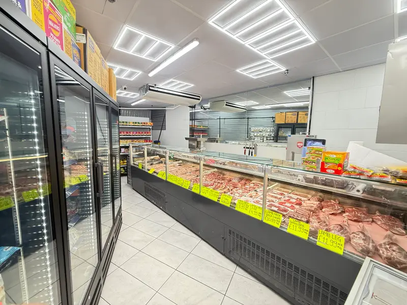 The fresh meat counter, with lamb and other cuts laid out in a long glass display